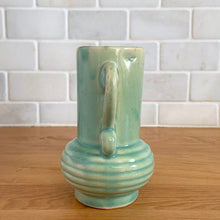 Load image into Gallery viewer, Rare vintage art deco Coronado Art Line pale green vase with double curled handles, 4A. Crafted by Brush McCoy Pottery, 1940s. This unique vase is a must-have for any art pottery collector. A lovely piece to use in your home decor or to give as a gift!

In excellent vintage condition, no chips/cracks/repairs. Marked on the bottom, A4 USA.

Measures 3 1/2 x 4 5/8 inches (incl. handles)
