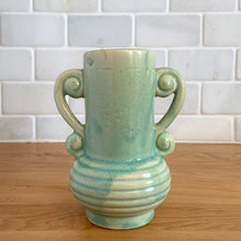 Load image into Gallery viewer, Rare vintage art deco Coronado Art Line pale green vase with double curled handles, 4A. Crafted by Brush McCoy Pottery, 1940s. This unique vase is a must-have for any art pottery collector. A lovely piece to use in your home decor or to give as a gift!

In excellent vintage condition, no chips/cracks/repairs. Marked on the bottom, A4 USA.

Measures 3 1/2 x 4 5/8 inches (incl. handles)
