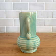 Load image into Gallery viewer, Rare vintage art deco Coronado Art Line pale green vase with double curled handles, 4A. Crafted by Brush McCoy Pottery, 1940s. This unique vase is a must-have for any art pottery collector. A lovely piece to use in your home decor or to give as a gift!

In excellent vintage condition, no chips/cracks/repairs. Marked on the bottom, A4 USA.

Measures 3 1/2 x 4 5/8 inches (incl. handles)

