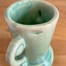 Load image into Gallery viewer, Rare vintage art deco Coronado Art Line pale green vase with double curled handles, 4A. Crafted by Brush McCoy Pottery, 1940s. This unique vase is a must-have for any art pottery collector. A lovely piece to use in your home decor or to give as a gift!

In excellent vintage condition, no chips/cracks/repairs. Marked on the bottom, A4 USA.

Measures 3 1/2 x 4 5/8 inches (incl. handles)
