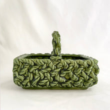 Load image into Gallery viewer, Adorable vintage mid-century dark green handled basket planter with a criss cross rope pattern and twisted rope design handle. Produced by Inarco, Japan, circa 1950s. A sweet basket for a few succulents, use a decor piece or candy dish.  In as found vintage condition, free from cracks/repairs, minor glaze chipping (see photos). Marked on the bottom. Original sticker.  Measures 5 3/4 x 4 1/4 x 3 3/4
