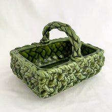 Load image into Gallery viewer, Adorable vintage mid-century dark green handled basket planter with a criss cross rope pattern and twisted rope design handle. Produced by Inarco, Japan, circa 1950s. A sweet basket for a few succulents, use a decor piece or candy dish.  In as found vintage condition, free from cracks/repairs, minor glaze chipping (see photos). Marked on the bottom. Original sticker.  Measures 5 3/4 x 4 1/4 x 3 3/4
