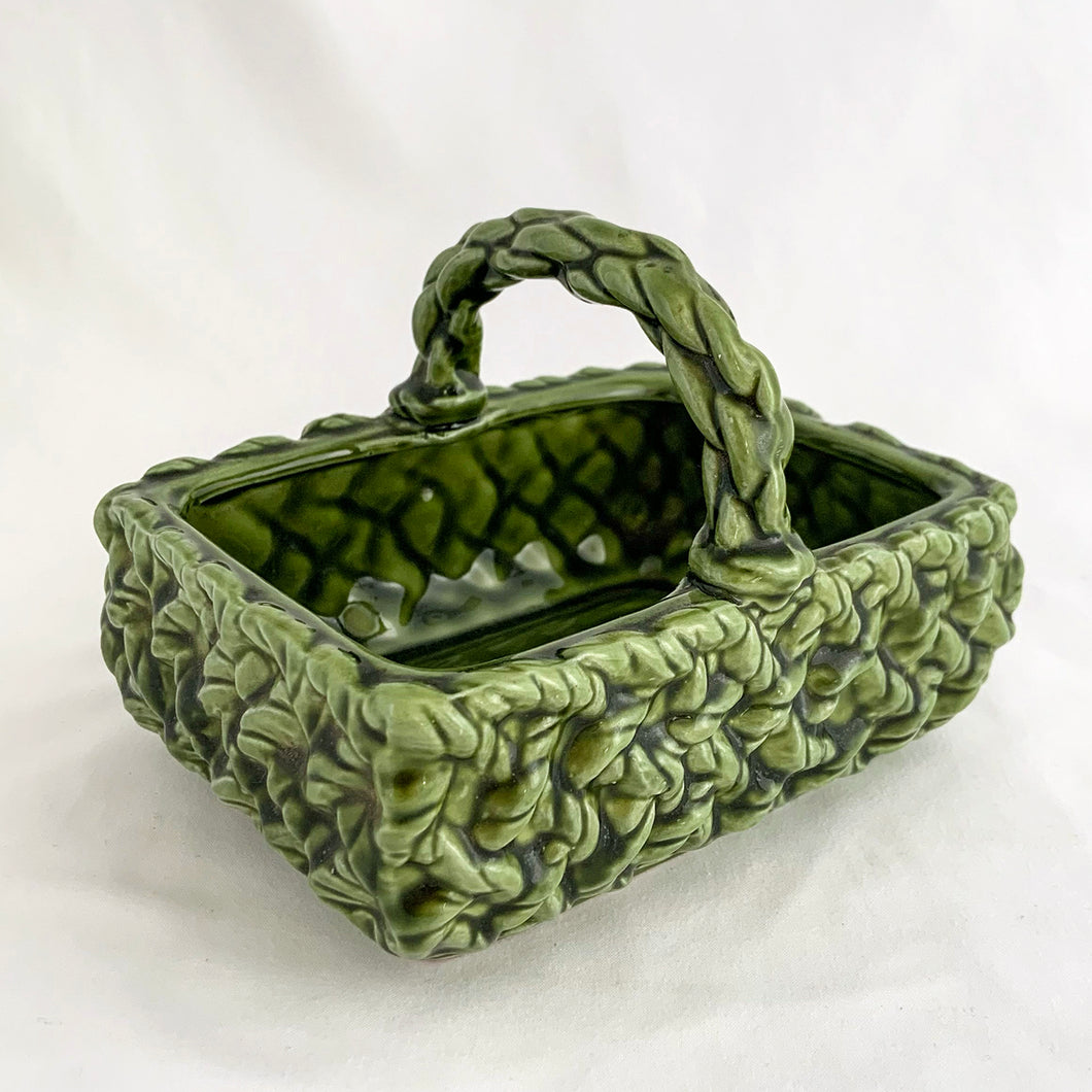 Adorable vintage mid-century dark green handled basket planter with a criss cross rope pattern and twisted rope design handle. Produced by Inarco, Japan, circa 1950s. A sweet basket for a few succulents, use a decor piece or candy dish.  In as found vintage condition, free from cracks/repairs, minor glaze chipping (see photos). Marked on the bottom. Original sticker.  Measures 5 3/4 x 4 1/4 x 3 3/4