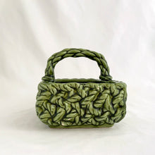 Load image into Gallery viewer, Adorable vintage mid-century dark green handled basket planter with a criss cross rope pattern and twisted rope design handle. Produced by Inarco, Japan, circa 1950s. A sweet basket for a few succulents, use a decor piece or candy dish.  In as found vintage condition, free from cracks/repairs, minor glaze chipping (see photos). Marked on the bottom. Original sticker.  Measures 5 3/4 x 4 1/4 x 3 3/4
