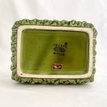 Load image into Gallery viewer, Adorable vintage mid-century dark green handled basket planter with a criss cross rope pattern and twisted rope design handle. Produced by Inarco, Japan, circa 1950s. A sweet basket for a few succulents, use a decor piece or candy dish.  In as found vintage condition, free from cracks/repairs, minor glaze chipping (see photos). Marked on the bottom. Original sticker.  Measures 5 3/4 x 4 1/4 x 3 3/4
