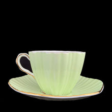 Load image into Gallery viewer, Side profile of vintage EB Foley 1850 scalloped bone china teacup, mint green with floral motif and gold gilt
