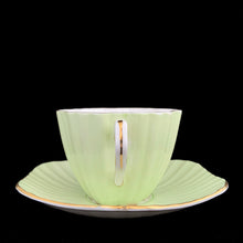 Load image into Gallery viewer, Handle view of vintage EB Foley 1850 scalloped bone china teacup, mint green with floral motif and gold gilt

