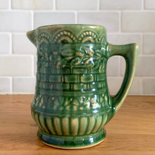 Load image into Gallery viewer, Antique vintage art deco gloss green Rosella no. 320 ceramic yellow ware pitcher featuring climbing roses on a basketweave pattern. Crafted by Robinson Clay Product Company, the precursor to Robinson Ransbottom Pottery, USA, early 1900s. A beautiful piece to add to your art pottery collection!

In excellent vintage condition, no chips/cracks/repairs, typical age-related crazing and manufacturer&#39;s glaze pops. Unmarked.

Measurements 5 1/4 x 5 inches (incl. spout/handle)
