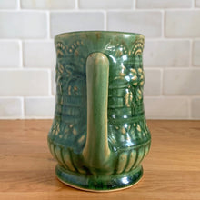 Load image into Gallery viewer, Antique vintage art deco gloss green Rosella no. 320 ceramic yellow ware pitcher featuring climbing roses on a basketweave pattern. Crafted by Robinson Clay Product Company, the precursor to Robinson Ransbottom Pottery, USA, early 1900s. A beautiful piece to add to your art pottery collection!

In excellent vintage condition, no chips/cracks/repairs, typical age-related crazing and manufacturer&#39;s glaze pops. Unmarked.

Measurements 5 1/4 x 5 inches (incl. spout/handle)
