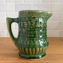 Load image into Gallery viewer, Antique vintage art deco gloss green Rosella no. 320 ceramic yellow ware pitcher featuring climbing roses on a basketweave pattern. Crafted by Robinson Clay Product Company, the precursor to Robinson Ransbottom Pottery, USA, early 1900s. A beautiful piece to add to your art pottery collection!

In excellent vintage condition, no chips/cracks/repairs, typical age-related crazing and manufacturer&#39;s glaze pops. Unmarked.

Measurements 5 1/4 x 5 inches (incl. spout/handle)
