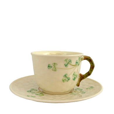 Vintage bone china demitasse flat cup and saucer, featuring delicate green shamrocks on cream ground impressed with a basketweave design. Crafted by Belleek, Ireland, 1965 - 1980. Makes a beautiful gift or addition to your collection!