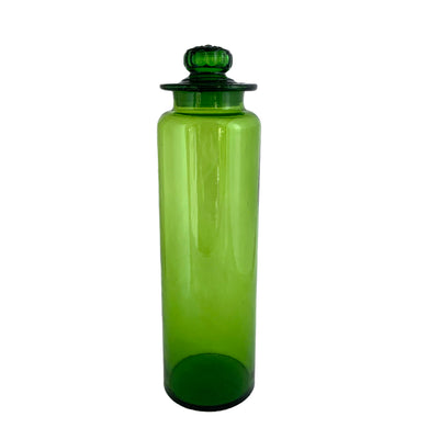 Striking vintage green hand blown art glass apothecary jar with ground lid. The finial on the lid features a flower design. Produced by Takahashi Glass, Japan, circa 1970. Perfect for food storage, or home decor. This fabulously happy colour will liven up any room, especially in a bright window! Good vintage condition with minor flea bite on the inside rim of the lid. Typical manufacturing imperfections in the glass such as bubbles and stringers. Measures 3 3/4 x 13 1/2 inches