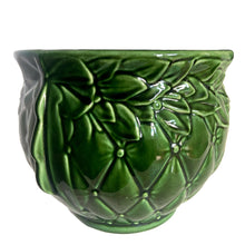 Load image into Gallery viewer, Large vintage TIerra Cushion jardiniere planter pot 1480, deep green shiny glaze, features an overlapping floral leaf pattern around the top rim, a diamond quilted body and ribbon handles. Crafted by McCoy Pottery during the Lancaster Colony Corporation Era, USA, 1974 - 1985. A must-have for any McCoy collector or gardener!

In excellent condition, free from chips, cracks or repairs, with a tiny manufacturer's defect, see photo. Maker's mark is on the bottom. Produced Measures 10 1/4 x 8 3/4 inches
