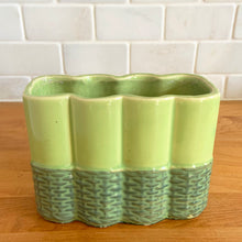Load image into Gallery viewer, Vintage mid-century two-tone green basketweave art pottery planter. Crafted by McCoy Pottery, USA, circa 1950s. A collectible art pottery planter that is perfect for forcing spring flower bulbs, planting succulent or a floral arrangement.

In excellent condition, no chips/cracks/repairs. Maker&#39;s mark.

Measures 5 5/8 x 2 1/2 x 4 1/4 inches
