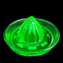 Load image into Gallery viewer, Vintage green uranium Depression era glass citrus fruit reamer. This piece is meant to fit on top of a measuring cup. Maker unknown. In used vintage condition, with flea bites to the outer rim and interior rim of the central section and one to the reamer. Measures 4 3/4 x 2 1/2 inches

