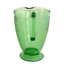 Load image into Gallery viewer, Vintage Florentine 1 green uranium depression era glass 36oz pitcher features a scalloped foot and glows beautifully under black light. Crafted by Hazel-Atlas Glass, USA, 1932 - 1935. Perfect for adding a touch of sophistication to any table setting or display in your uranium glass collection!

In excellent used vintage condition, no chips, minor wear.

Measures 7 x 4 7/8 x 6 3/4 inches (incl. handle/spout)
