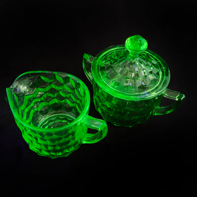 A cool vintage green uranium depression glass creamer and covered sugar in the 