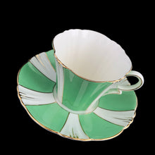 Load image into Gallery viewer, This antique art deco style white bone china teacup and saucer is simply elegant! Both the cup and saucer have a lovely square scalloped edge, hand painted in green colour blocks alternating with white along with gold gilt details and rim. Crafted by Royal Albert Crown China, England, between 1925 to 1927. A beautiful old piece that has stood the test of time!
