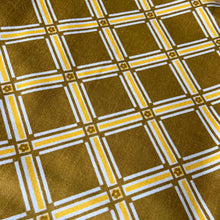 Load image into Gallery viewer, Vintage geometric tartan patterned fabric remnant with flower detail in olive green and yellow and white. Crafted by 5th Avenue Design, USA. Label states Copyright - USA 5th Avenue Design Inc. Vat Dyes - preshrunk Permanent Schreinered Protected With COVGARD - Screen Printed. Perfect for home decor crafting!

In excellent condition, no stains/tears.

Measures 24 1/2 x 108 inches / 3 yards

