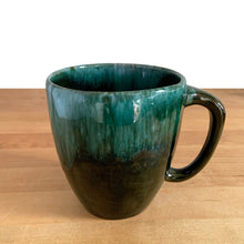 Load image into Gallery viewer, This fabulous vintage green and black drip glazed mug was produced by Blue Mountain Pottery, the pride of Collingwood, Canada, circa 1970. Perfect for your morning cuppa!

Excellent condition, no chips or cracks.

Measures 4 x 4 inches (without handle)
