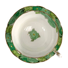 Load image into Gallery viewer, Vintage Chrysanthemum fine bone china teacup and saucer featuring flowers in shades of green and gold gilt trim. Crafted by Paragon, England, 1923-33. A lovely way to enjoy a cuppa tea!

In excellent condition, no chips, cracks or repairs. Maker&#39;s mark on the bottom.

Measures 4 x 2 3/8 inches | Saucer measures 5 1/2 inches
