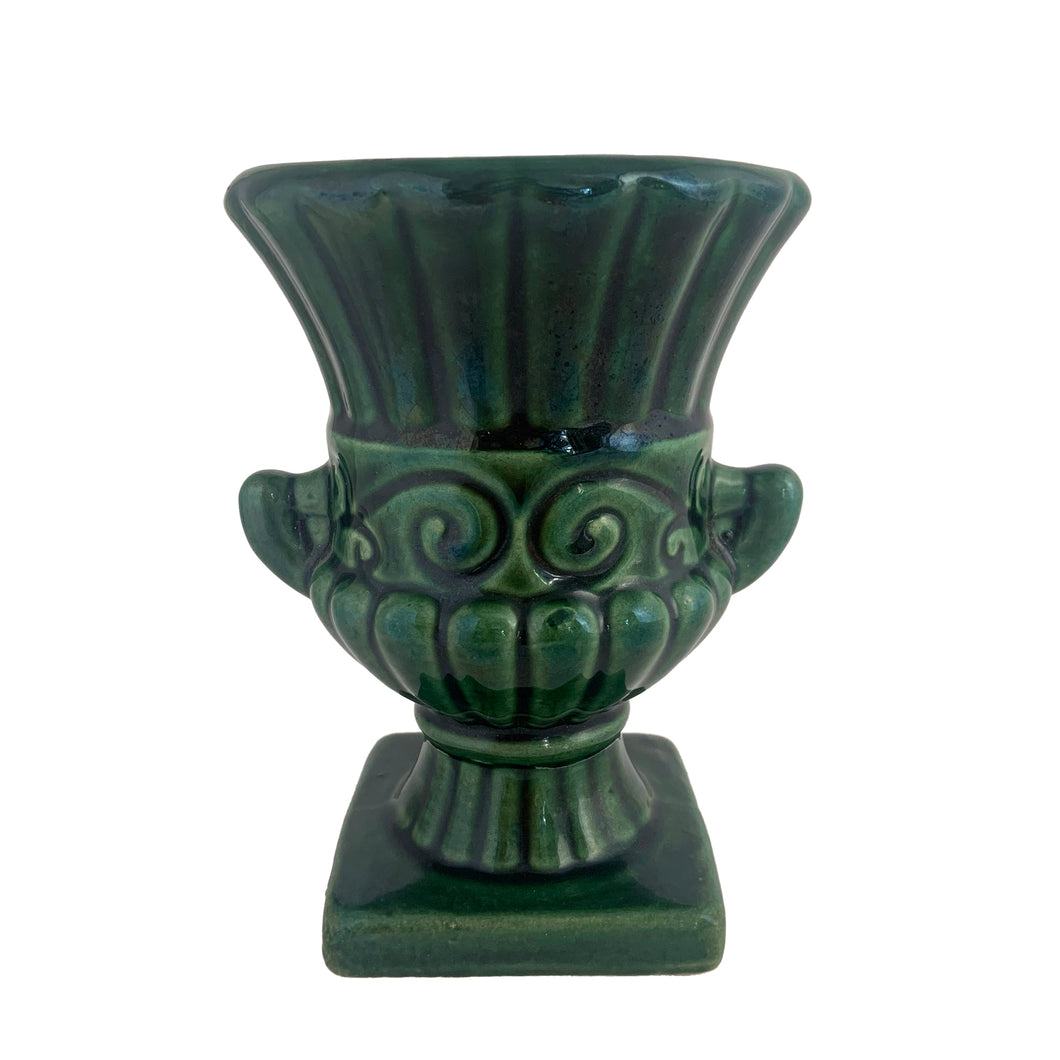 Vintage mid-century green pedestal urn shaped vase with handles and ribbed pattern. Crafted by Beauce, Canada, 1960s. This lovely vase is must for any art pottery collector!

In excellent condition, no chips/cracks/repairs, crazing commensurate with age, typical manufacturing glaze pops. Maker's mark on the bottom.

Measures 4 x 5 1/2 inches