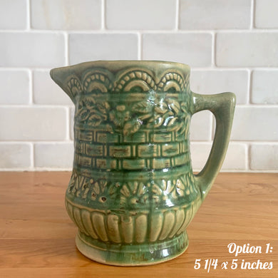 Antique vintage art deco gloss green Rosella 320 ceramic yellow ware pitcher featuring climbing roses on a basketweave pattern. Crafted by Robinson Clay Product Company, the precursor to Robinson Ransbottom Pottery, USA, early 1900s. A beautiful piece to add to your art pottery collection! Option 1, 5 1/4 x 5 inches
In as found vintage condition, no chips/repairs, tiny crack at the spout, age-related crazing. Typical manufacturing glaze pops. Unmarked.