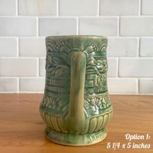Load image into Gallery viewer, Antique vintage art deco gloss green Rosella 320 ceramic yellow ware pitcher featuring climbing roses on a basketweave pattern. Crafted by Robinson Clay Product Company, the precursor to Robinson Ransbottom Pottery, USA, early 1900s. A beautiful piece to add to your art pottery collection! Option 1, 5 1/4 x 5 inches
In as found vintage condition, no chips/repairs, tiny crack at the spout, age-related crazing. Typical manufacturing glaze pops. Unmarked.
