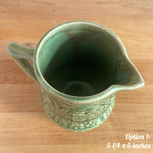 Load image into Gallery viewer, Antique vintage art deco gloss green Rosella 320 ceramic yellow ware pitcher featuring climbing roses on a basketweave pattern. Crafted by Robinson Clay Product Company, the precursor to Robinson Ransbottom Pottery, USA, early 1900s. A beautiful piece to add to your art pottery collection! Option 1, 5 1/4 x 5 inches
In as found vintage condition, no chips/repairs, tiny crack at the spout, age-related crazing. Typical manufacturing glaze pops. Unmarked.
