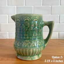 Load image into Gallery viewer, Antique vintage art deco gloss green Rosella 320 ceramic yellow ware pitcher featuring climbing roses on a basketweave pattern. Crafted by Robinson Clay Product Company, the precursor to Robinson Ransbottom Pottery, USA, early 1900s. A beautiful piece to add to your art pottery collection! Option 2, 5 1/4 x 5 inches
In as found vintage condition, no chips/repairs, tiny cracks at the spout, age-related crazing. Typical manufacturing glaze pops. Unmarked.
