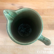 Load image into Gallery viewer, Antique vintage art deco gloss green Rosella 320 ceramic yellow ware pitcher featuring climbing roses on a basketweave pattern. Crafted by Robinson Clay Product Company, the precursor to Robinson Ransbottom Pottery, USA, early 1900s. A beautiful piece to add to your art pottery collection! Option 3: 6 x 7 5/8 inches. In excellent vintage condition, no chips/cracks/repairs, age-related crazing. Typical manufacturing glaze pops. Unmarked.
