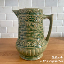 Load image into Gallery viewer, Antique vintage art deco gloss green Rosella 320 ceramic yellow ware pitcher featuring climbing roses on a basketweave pattern. Crafted by Robinson Clay Product Company, the precursor to Robinson Ransbottom Pottery, USA, early 1900s. A beautiful piece to add to your art pottery collection! Option 4, 6 1/2 x 7 1/2 inches
In excellent vintage condition, no chips/cracks/repairs, age-related crazing. Typical manufacturing glaze pops. Unmarked.
