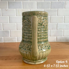 Load image into Gallery viewer, Antique vintage art deco gloss green Rosella 320 ceramic yellow ware pitcher featuring climbing roses on a basketweave pattern. Crafted by Robinson Clay Product Company, the precursor to Robinson Ransbottom Pottery, USA, early 1900s. A beautiful piece to add to your art pottery collection! Option 4, 6 1/2 x 7 1/2 inches
In excellent vintage condition, no chips/cracks/repairs, age-related crazing. Typical manufacturing glaze pops. Unmarked.
