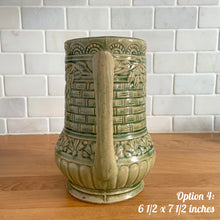 Load image into Gallery viewer, Antique vintage art deco gloss green Rosella 320 ceramic yellow ware pitcher featuring climbing roses on a basketweave pattern. Crafted by Robinson Clay Product Company, the precursor to Robinson Ransbottom Pottery, USA, early 1900s. A beautiful piece to add to your art pottery collection! Option 4, 6 1/2 x 7 1/2 inches
In excellent vintage condition, no chips/cracks/repairs, age-related crazing. Typical manufacturing glaze pops. Unmarked.
