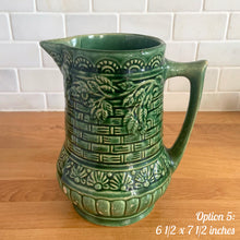 Load image into Gallery viewer, Antique vintage art deco gloss green Rosella 320 ceramic yellow ware pitcher featuring climbing roses on a basketweave pattern. Crafted by Robinson Clay Product Company, the precursor to Robinson Ransbottom Pottery, USA, early 1900s. A beautiful piece to add to your art pottery collection! Option 5, 6 1/2 x 7 1/2 inches
In as found vintage condition, no cracks/repairs, chips to handle, age-related crazing and large manufacturing glaze pops. Maker&#39;s marks.
