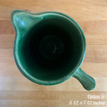 Load image into Gallery viewer, Antique vintage art deco gloss green Rosella 320 ceramic yellow ware pitcher featuring climbing roses on a basketweave pattern. Crafted by Robinson Clay Product Company, the precursor to Robinson Ransbottom Pottery, USA, early 1900s. A beautiful piece to add to your art pottery collection! Option 5, 6 1/2 x 7 1/2 inches
In as found vintage condition, no cracks/repairs, chips to handle, age-related crazing and large manufacturing glaze pops. Maker&#39;s marks.
