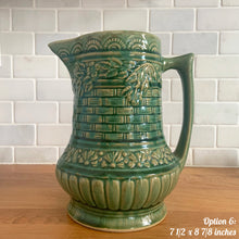 Load image into Gallery viewer, Antique vintage art deco gloss green Rosella 320 ceramic yellow ware pitcher featuring climbing roses on a basketweave pattern. Crafted by Robinson Clay Product Company, the precursor to Robinson Ransbottom Pottery, USA, early 1900s. A beautiful piece to add to your art pottery collection! Option 6, 7 1/2 x 8 7/8 inches. In excellent vintage condition, no chips/cracks/repairs, age-related crazing. Typical manufacturing glaze pops. Unmarked.
