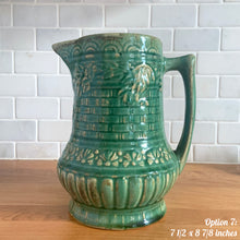 Load image into Gallery viewer, Antique vintage art deco gloss green Rosella 320 ceramic yellow ware pitcher featuring climbing roses on a basketweave pattern. Crafted by Robinson Clay Product Company, the precursor to Robinson Ransbottom Pottery, USA, early 1900s. A beautiful piece to add to your art pottery collection! Option 7, 7 1/2 x 8 7/8 inches. In excellent vintage condition, no chips/cracks/repairs, age-related crazing. Typical manufacturing glaze pops. Unmarked.
