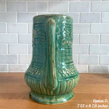 Load image into Gallery viewer, Antique vintage art deco gloss green Rosella 320 ceramic yellow ware pitcher featuring climbing roses on a basketweave pattern. Crafted by Robinson Clay Product Company, the precursor to Robinson Ransbottom Pottery, USA, early 1900s. A beautiful piece to add to your art pottery collection! Option 7, 7 1/2 x 8 7/8 inches. In excellent vintage condition, no chips/cracks/repairs, age-related crazing. Typical manufacturing glaze pops. Unmarked.
