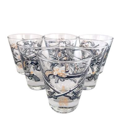Set of six vintage wild west themed double shot glasses featuring revolvers and pistols in black, white and gold. Crafted by Libbey Glass, circa 1950s. A great addition to your barware collection!
In excellent condition, no chips. Marked on the bottom with the Libbey L.

Measures 2 3/4 x 3 inches

Capacity 2 ounces