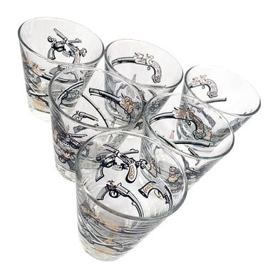 Set of six vintage wild west themed double shot glasses featuring revolvers and pistols in black, white and gold. Crafted by Libbey Glass, circa 1950s. A great addition to your barware collection!
In excellent condition, no chips. Marked on the bottom with the Libbey L.

Measures 2 3/4 x 3 inches

Capacity 2 ounces