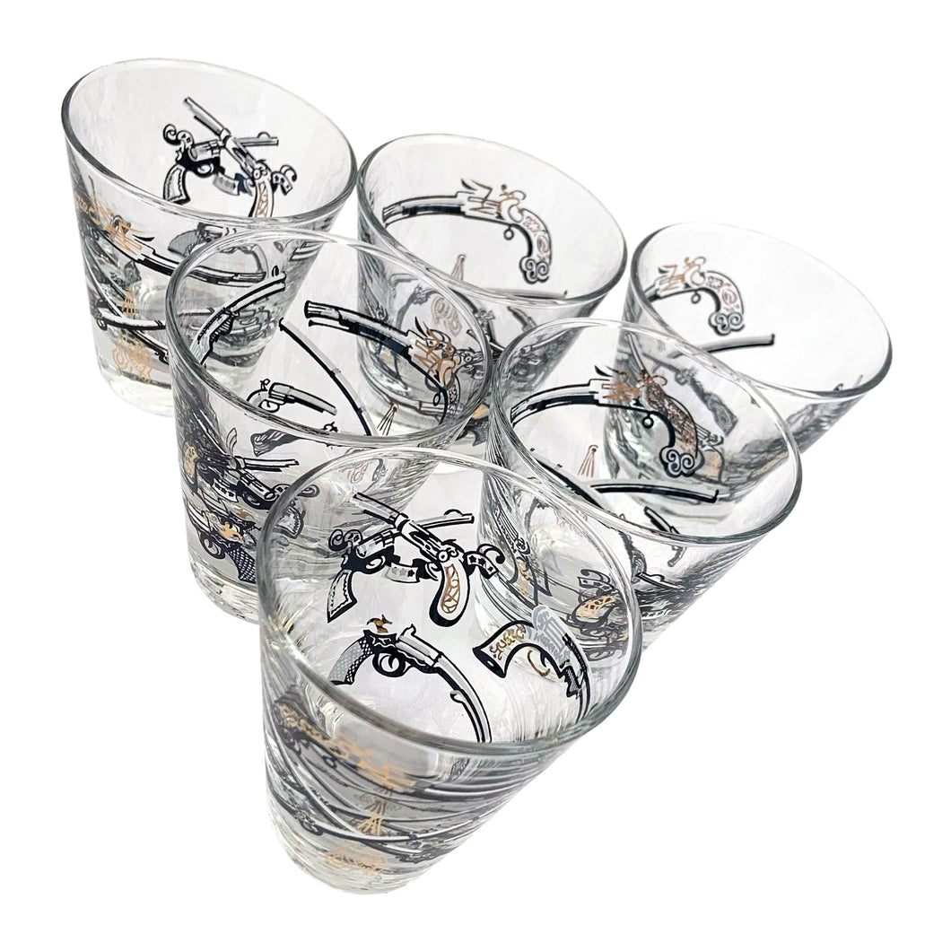 Set of six vintage wild west themed double shot glasses featuring revolvers and pistols in black, white and gold. Crafted by Libbey Glass, circa 1950s. A great addition to your barware collection!
In excellent condition, no chips. Marked on the bottom with the Libbey L.

Measures 2 3/4 x 3 inches

Capacity 2 ounces