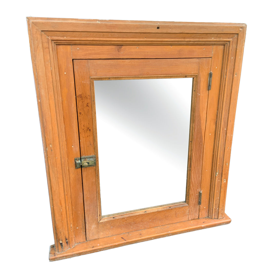 This early 20th-century rustic medicine cabinet exemplifies the craftsmanship of Toronto's heritage homes. Salvaged from a period residence, it features solid wood construction paired with an original mirrored door—a hallmark of vintage bathroom fixtures. The cabinet's authentic patina and period-appropriate brass hardware reflect decades of domestic use, making it a distinctive accent for collectors and design enthusiasts seeking genuine antique character. Ideal for display or functional storage. 
