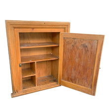 Load image into Gallery viewer, This early 20th-century rustic medicine cabinet exemplifies the craftsmanship of Toronto&#39;s heritage homes. Salvaged from a period residence, it features solid wood construction paired with an original mirrored door—a hallmark of vintage bathroom fixtures. The cabinet&#39;s authentic patina and period-appropriate brass hardware reflect decades of domestic use, making it a distinctive accent for collectors and design enthusiasts seeking genuine antique character. Ideal for display or functional storage. 
