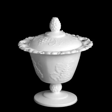 Vintage Harvest white milk glass footed candy dish with lid features an embossed grapevine pattern and lace edge. Crafted by Indiana Glass, USA, 1960s/70s. Perfect for housing your favourite sweet treats!

In excellent condition, no chips.

Measures 5 7/8 x 6 3/4 inches