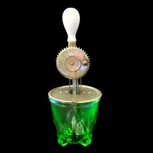 Load image into Gallery viewer, Green uranium glass hand beater glowing under blacklight showing fluorescent properties of Depression glass 
