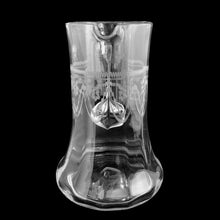 Load image into Gallery viewer, Spout view of Heisey No. 3350 Trefoil tatting pitcher showing needle-etched swag, bow, and floral motifs on panel-optic cylinder body with flared base — c. 1917–1928
