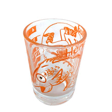 Load image into Gallery viewer, Vintage Here&#39;s Mud in Your Eye novelty bar measure featuring a clumsy fisherman and 1, 2, 3 and 4 ounce levels printed in orange on clear glass. Maker unknown, 1970s.

In as found vintage condition, no chips, some wear to inside bottom.

Measures 2 1/4 x 3 inches
