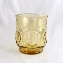 Load image into Gallery viewer, Vintage retro &quot;Heritage Hill&quot; 8oz on the rocks glass. Crafted by Anchor Hocking, USA, circa 1976. These glasses feature a textured finish with 6 embossed circles around the body, a flared top and tapered base. Perfect for the bevvy of your choice...cheers!  In excellent condition, free from chips, minimal wear.  Measures 3 1/4 x 3 inches  Capacity 8 ounces
