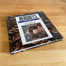 Load image into Gallery viewer, This fabulous vintage hardcover cookbook features decadent cake recipes straight from the makers of Hershey&#39;s chocolate, one of the world&#39;s most recognizable brands! Its 122 pages are filled with amazing recipes along with many colour photographs. All recipes developed by Marjorie Anderson and tested in the Hershey Kitchens. Published by Joshua Morris Publishing, 1992.   In great  condition!   
